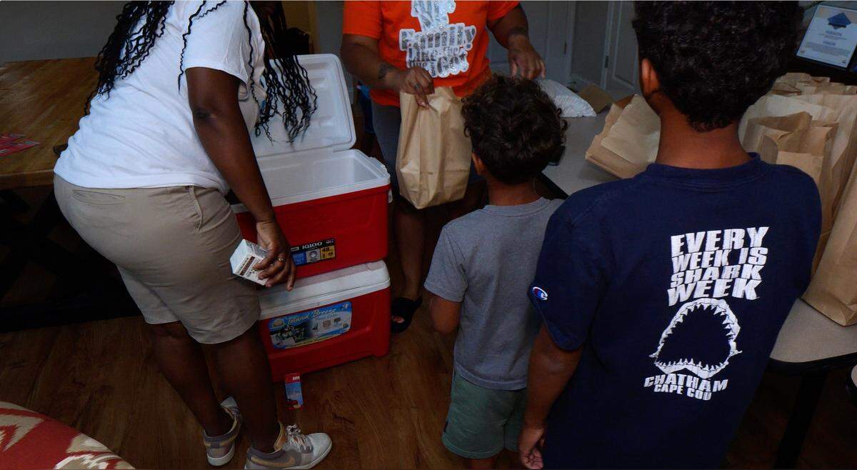 Lunches are handed out to children through the Happy Endings program.