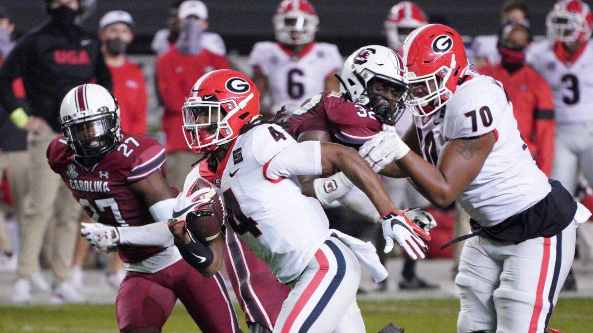 Georgia running back James Cook (4) carries the ball for a touchdown during the first half of the team’s NCAA college football game against South Carolina on Saturday, Nov. 28, 2020, in Columbia, S.C. (AP Photo/Sean Rayford)