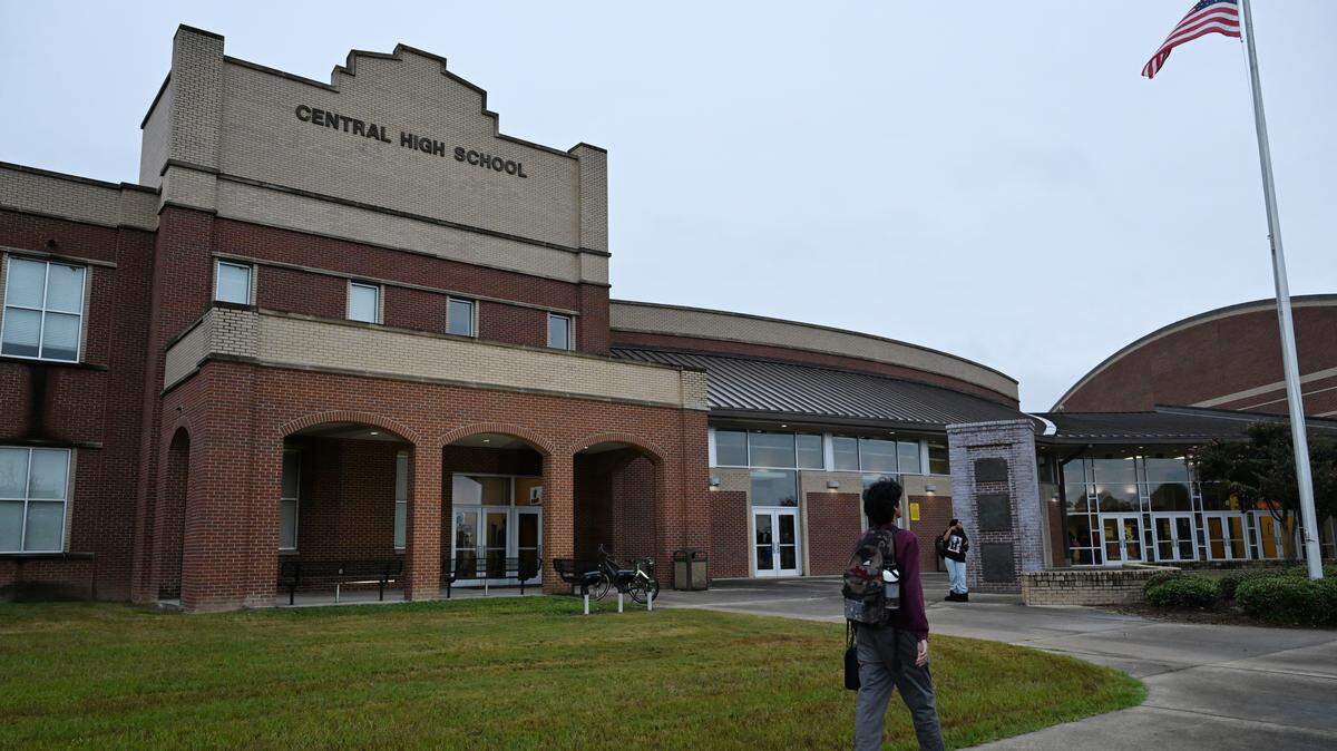 A student walks in front of Central High School on the first day of the 2025-2026 school year on Monday, Aug. 4, 2025, in Macon, Georgia.