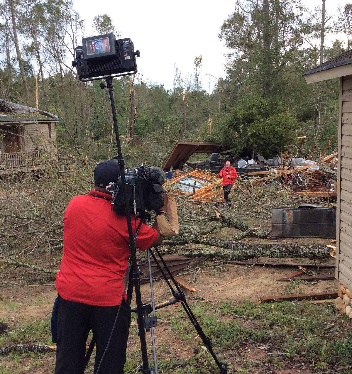 An Atlanta TV news crew reports from Wayne Granade’s yard in western Crawford County on Thursday after an apparent tornado spun off by Hurricane Michael roared through on Wednesday afternoon.