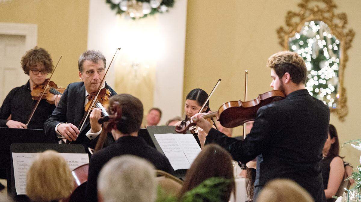 Robert McDuffie performs with students of the McDuffie Center for Strings at the Macon Rotary Club Christmas Party Monday night at Idle Hour Country Club.