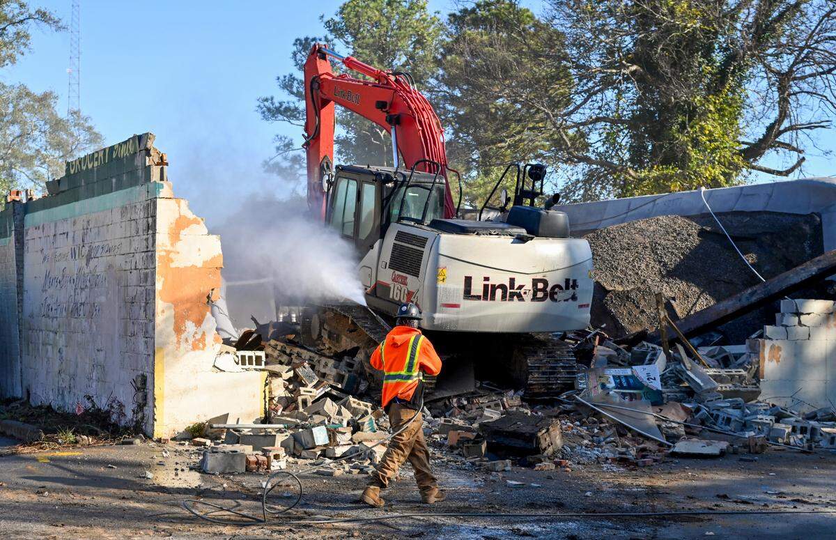 An excavator tearing down the former Bateman and Wade Grocery at 2283 Clayton St.