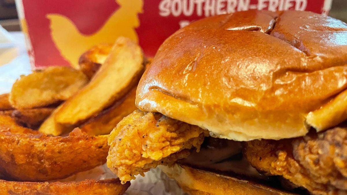 A classic chicken sandwich with potato wedges from Raise the Roost Chicken & Biscuits.