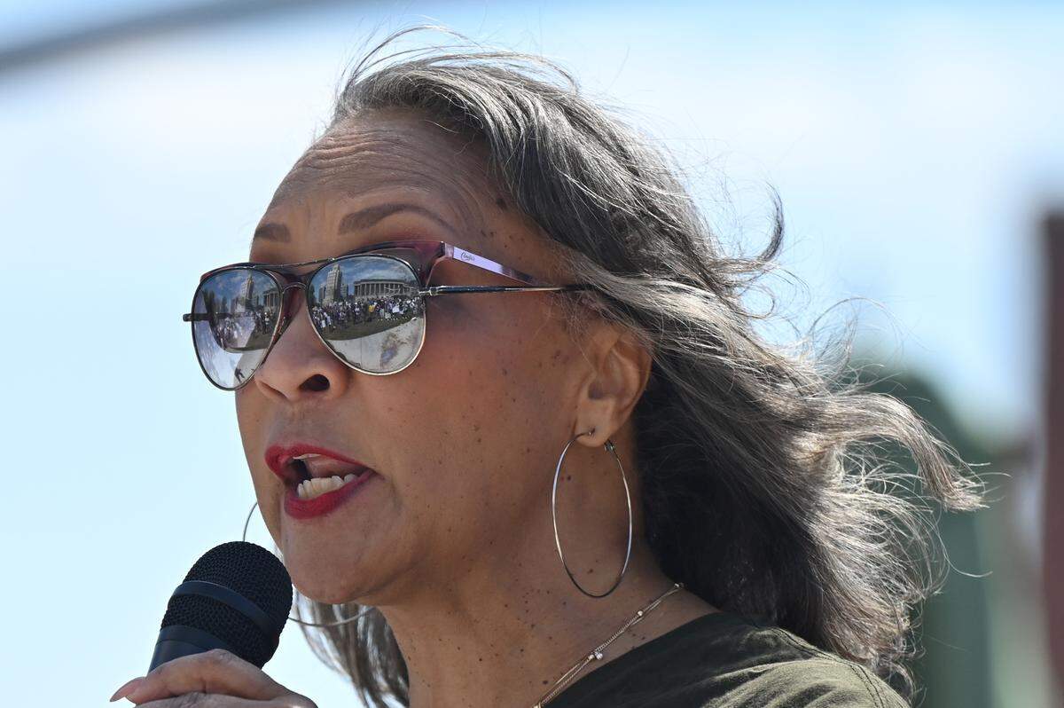 No Kings Protest attendees reflect in the sunglasses of Georgia State Rep. Miriam Paris on Saturday, March 28, 2026, in Macon, Ga. Several hundred attendees gathered in Rosa Parks Square as part of a national day of protest against President Donald Trump’s administration.