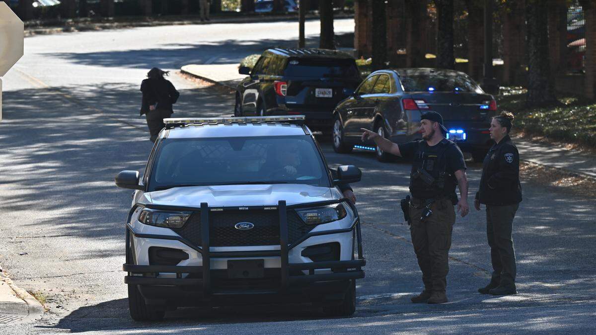 A Bibb County Sheriff’s Office vehicle drives away from the Emily Parker Myers Admissions and Welcome Center on Tuesday, Nov. 11, 2025, at Mercer University in Macon, Georgia. Bibb County police assisted Mercer University Police in responding to an active bomb threat investigation at the admissions building Tuesday afternoon.