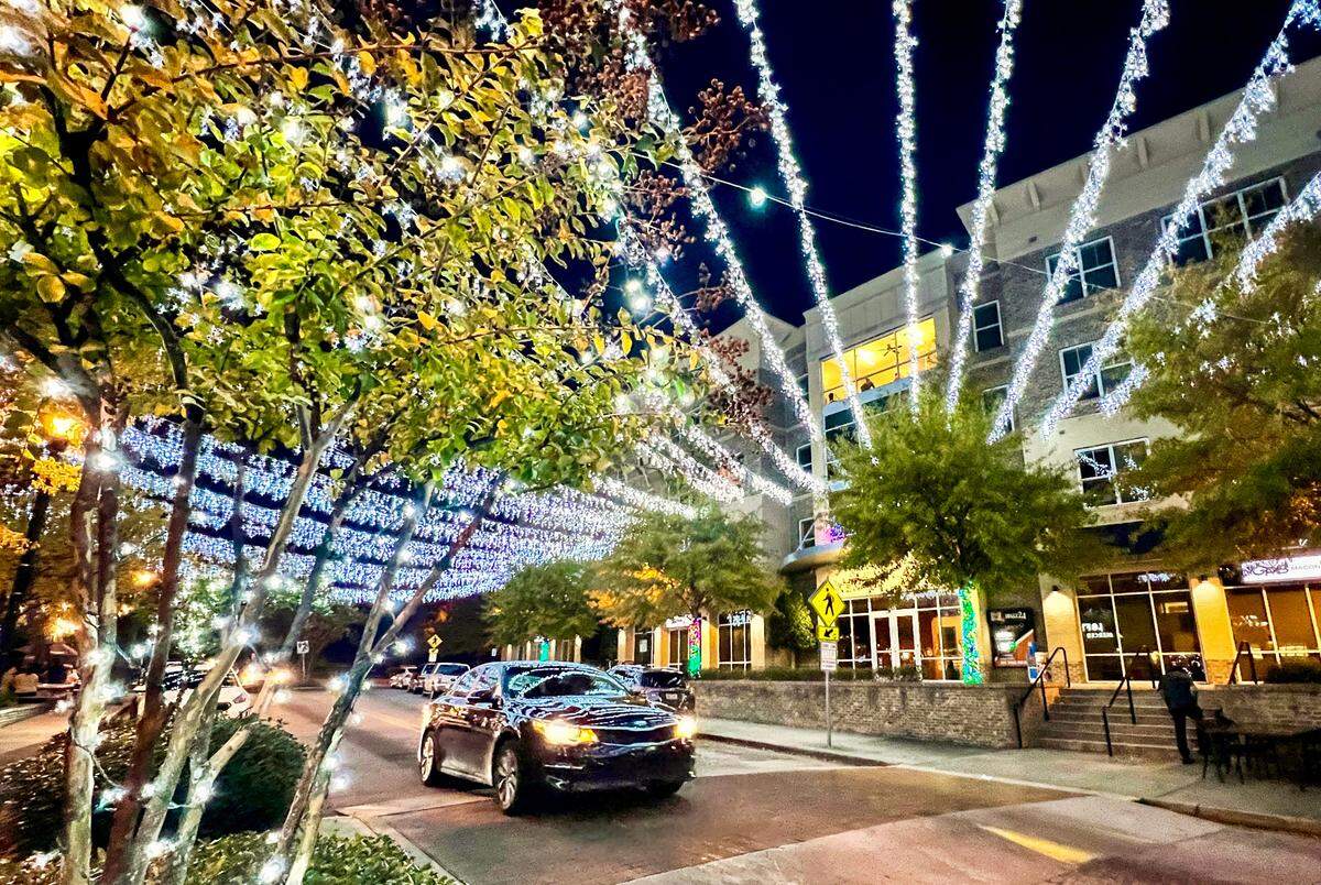 A car drives under a canopy of Christmas lights on Montpelier Avenue Tuesday night in Mercer Village. The annual Light More Homes display that opens Thursday night features 170 oak trees from Montpelier Avenue to Stadium Drive wrapped in red and white lights. The new section added 55,000 lights, 24,000 feet of power cable and 7,000 feet of Cat 5 cable.