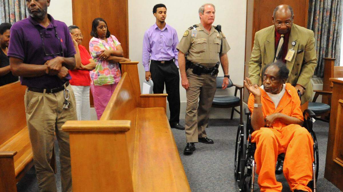 Frank Reeves waves at family members and supporters as he is pushed out of the courtroom in 2013, when he asked the court for bond so he could move into a health care facility in Macon. 