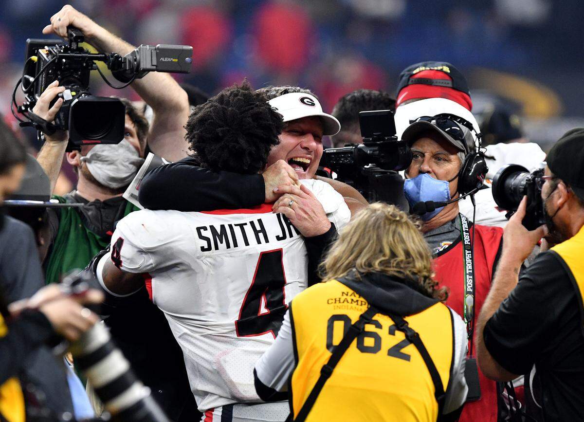 Georgia head coach Kirby Smart celebrates with Nolan Smith (4) after the Bulldogs’ 33-18 win over Alabama in the College Football Playoff National Championship game Monday night.