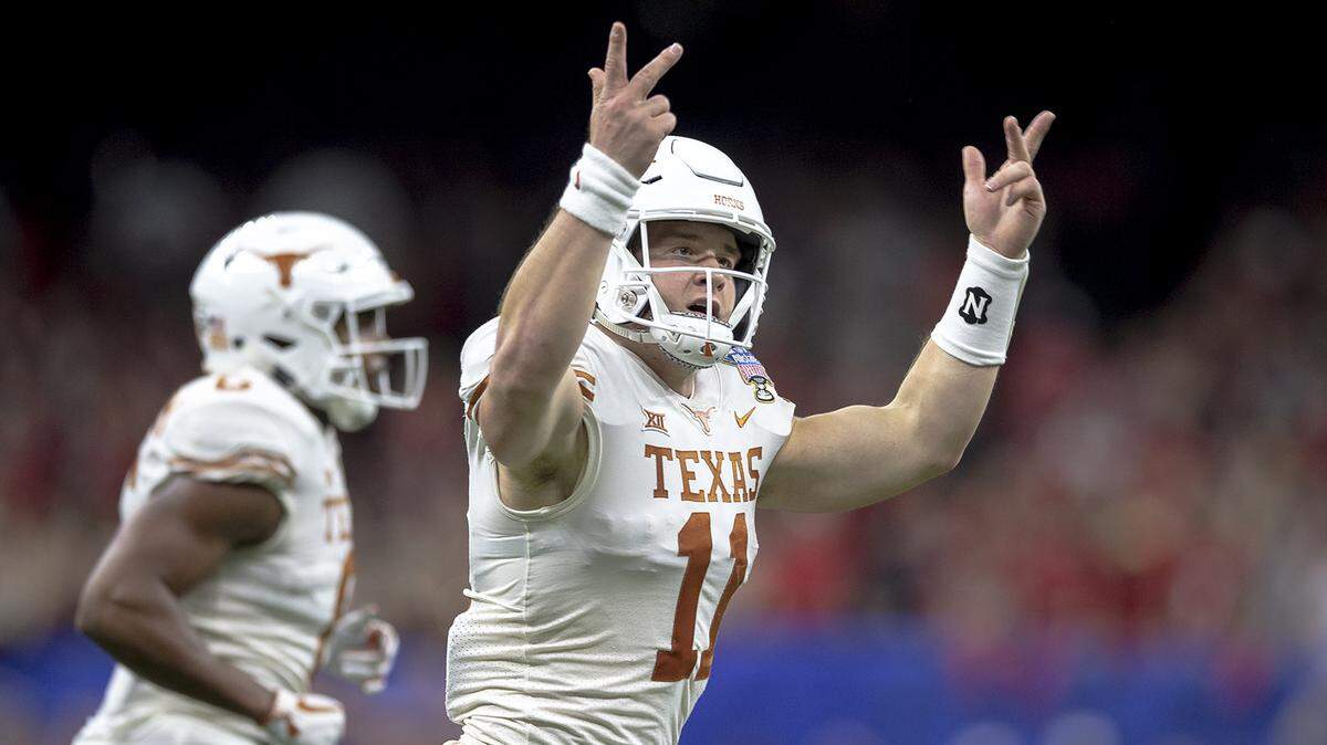 Texas quarterback Sam Ehlinger (11) celebrates one of his touchdowns against Georgia during the first half of the Sugar Bowl NCAA college football game Tuesday, Jan. 1, 2019, in New Orleans. (Nick Wagner/Austin American-Statesman via AP)