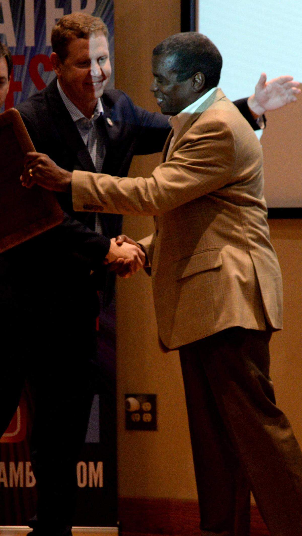 JENNA EASON/THE TELEGRAPH Macon, GA, 12/05/2019: Ron Shipman, with Georgia Power, presents the 2019 MEDC Champion Award to Gary Wheat, president and CEO of Visit Macon, left to right, at the Greater Macon Chamber of Commerce’s 159th annual meeting at the Museum of Arts and Sciences on Thursday.