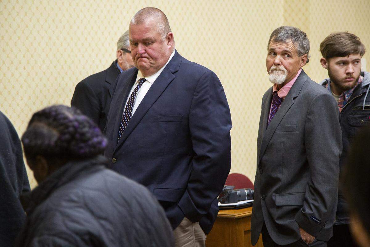 Former Washington County Deputies Michael Howell, center, and Rhett Scott, right, leave the court room in Washington County after a delay in their retrial on murder charges stemming from the 2017 death of Eurie Martin. Not pictured is third defendant Henry Copeland.