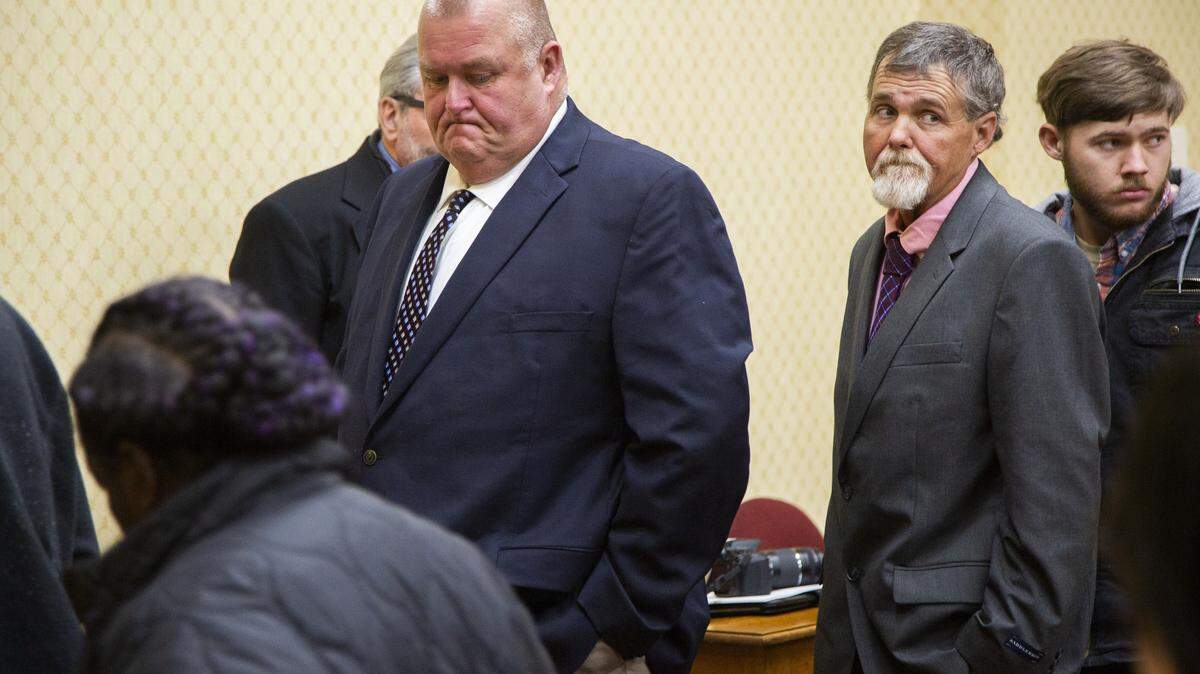 Former Washington County Deputies Michael Howell, center, and Henry Copeland, right, leave the court room in Washington County after a delay in their retrial on murder charges stemming from the 2017 death of Eurie Martin. Not pictured is third defendant Rhett Scott.