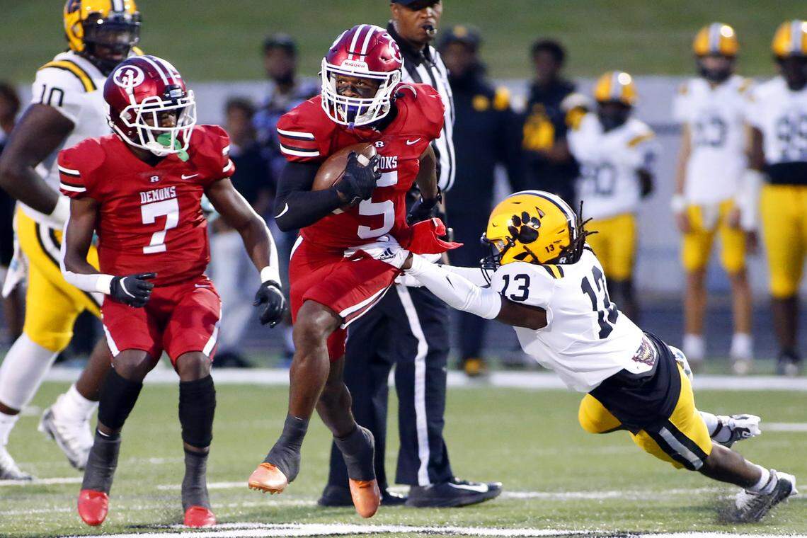 Warner Robins’ Chaz Strun (5) breaks a tackle in the first quarter of the Demons 25-0 loss to Valdosta Friday night.