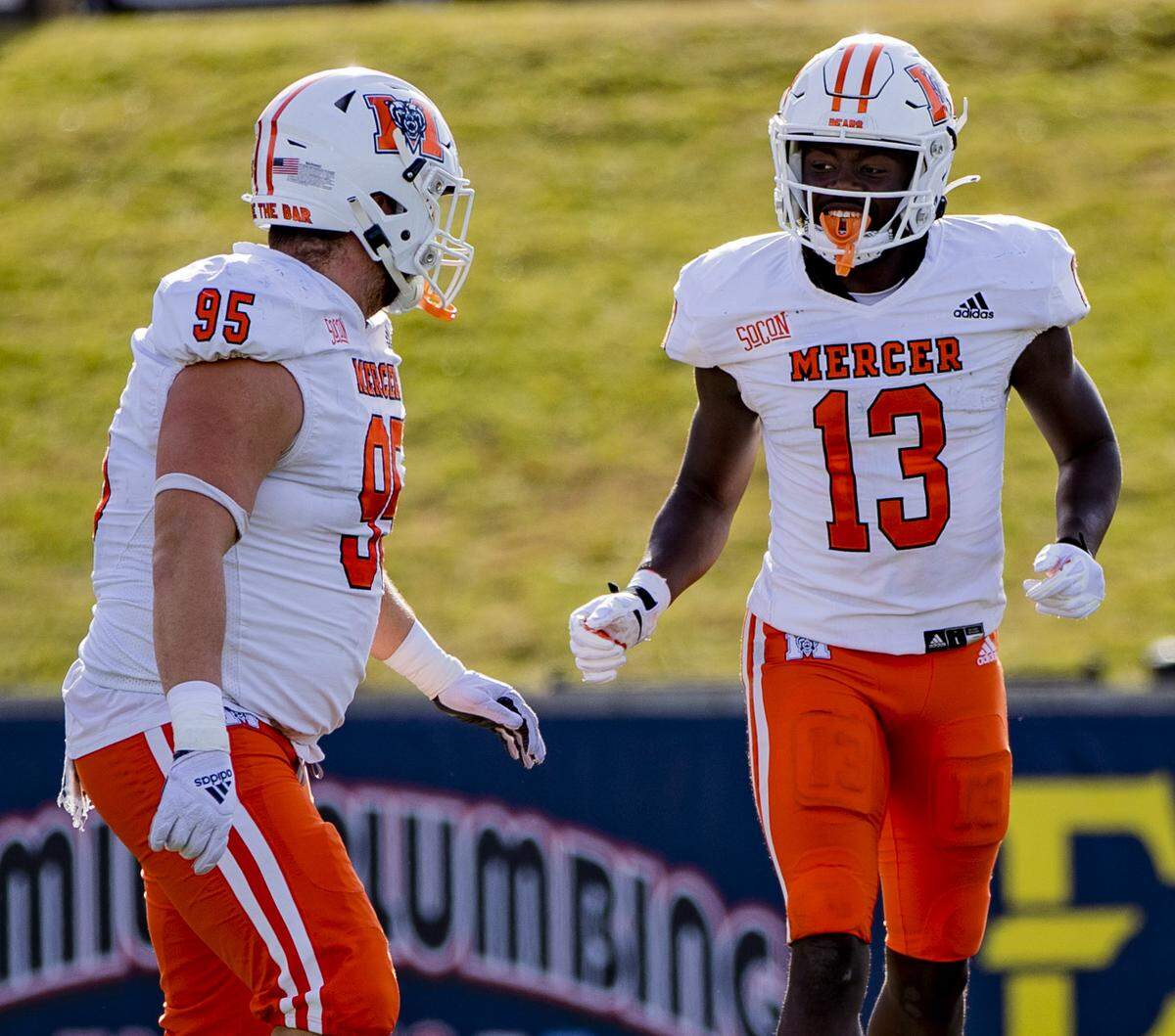Mercer junior defensive lineman Barron King (95) and freshman receiver Ty James (13) jog off the field after a touchdown against Eastern Tennessee State Saturday afternoon at William B. Greene Jr. Stadium in Johnson City, Tenn. ETSU defeated Mercer 38-35.
