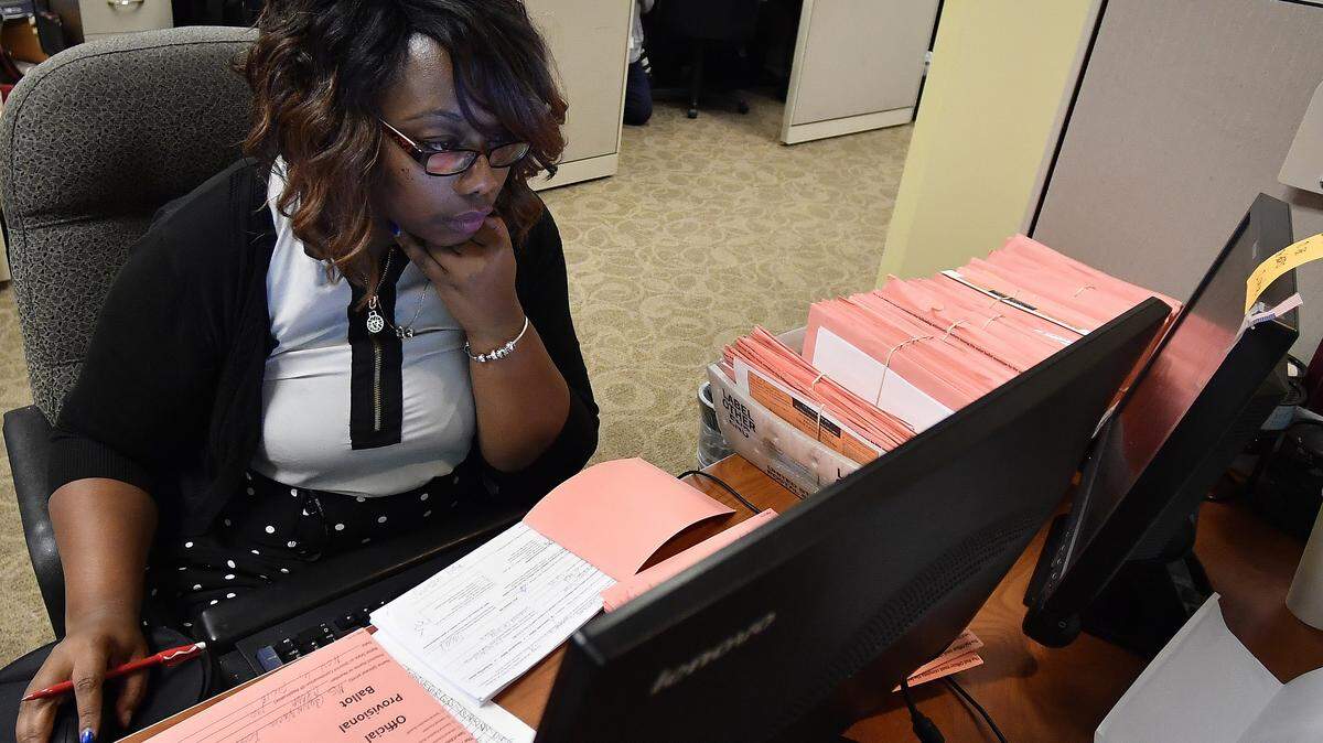 A Fulton County election worker counts provisional ballots Nov. 7 in Atlanta.