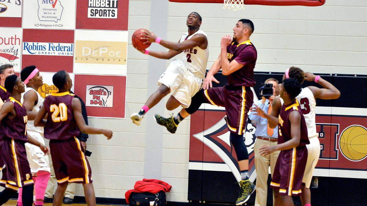 Howard's Robert Jarrell (3) puts up a shot over Perry's Chris Clerkley (24) during their game Friday night.