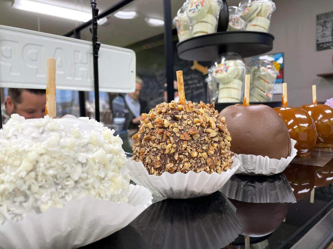 Gourmet caramel apples lined up for packaging after being selected by a customer at The Apple Basket in Centerville at its reopening Monday, May 5, 2025.