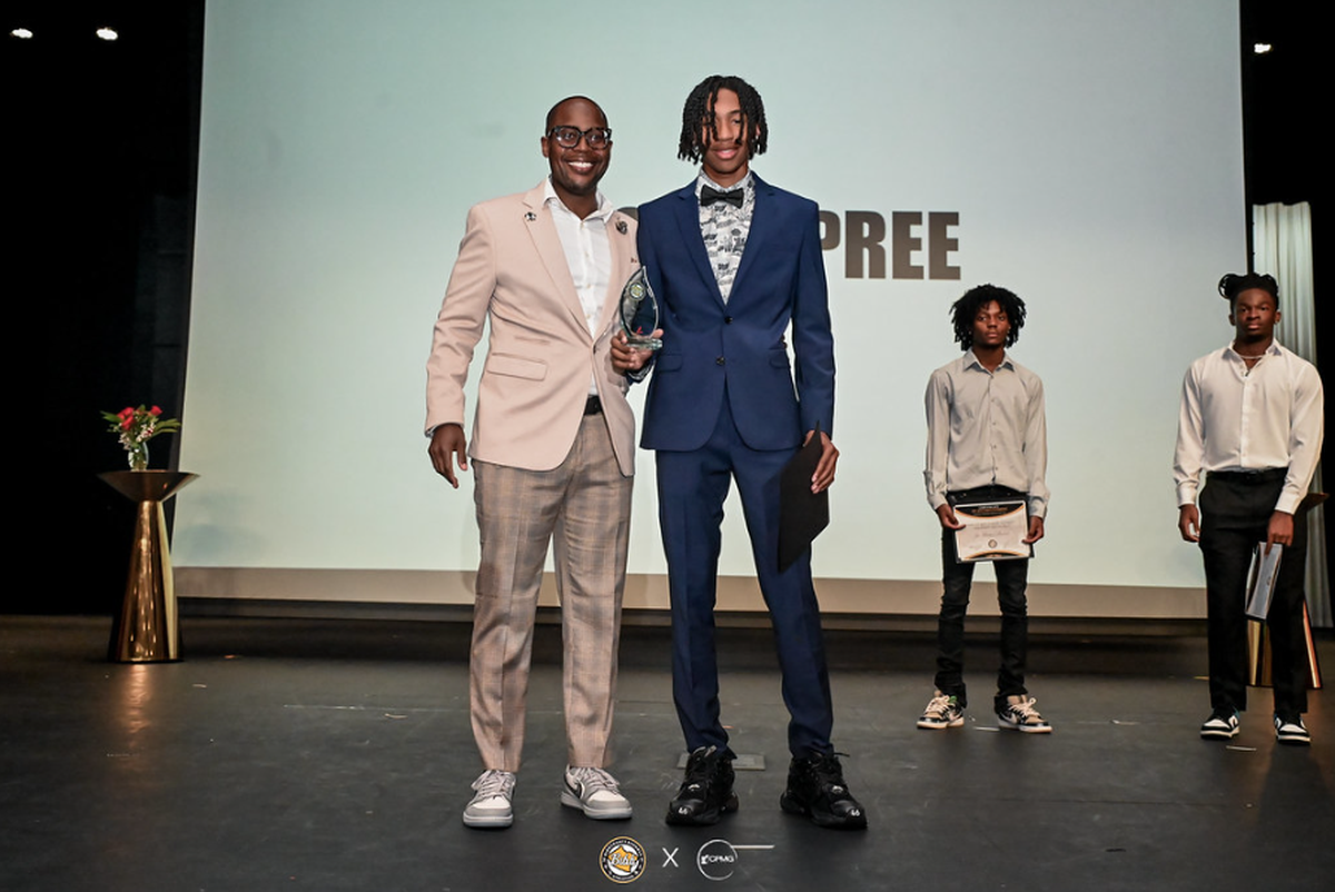 Bibb County Athletic Director Kevin Grooms congratulates high school student Chase Dupree for winning Football Offensive Player of the Year during the BIBBSY ’24 Sports Awards.