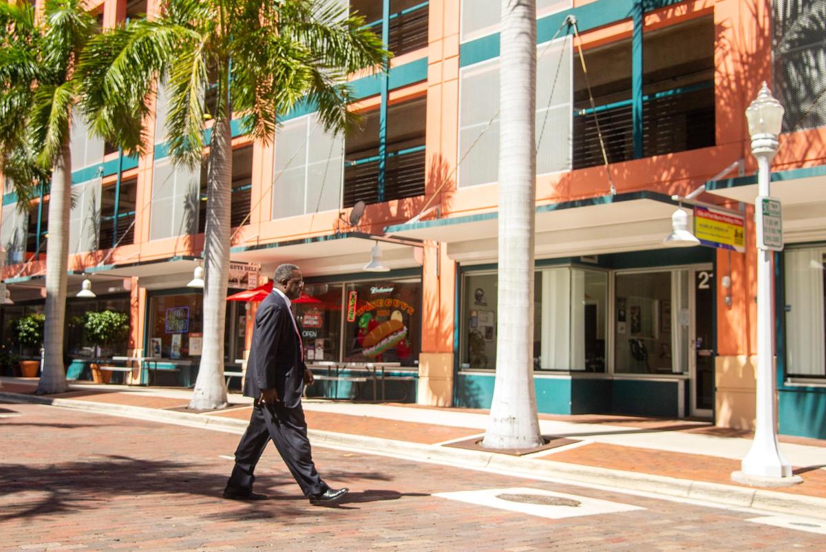 Ex-Bibb County schools superintendent Romain Dallemand walks to his car across in a parking garage across from U.S. District Court in Fort Myers, Fla., Thursday morning after his sentencing for tax evasion.