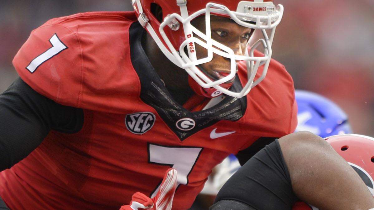 Jonathan Ledbetter (13) is in on a tackle during Georgia's game against Kentucky last season.