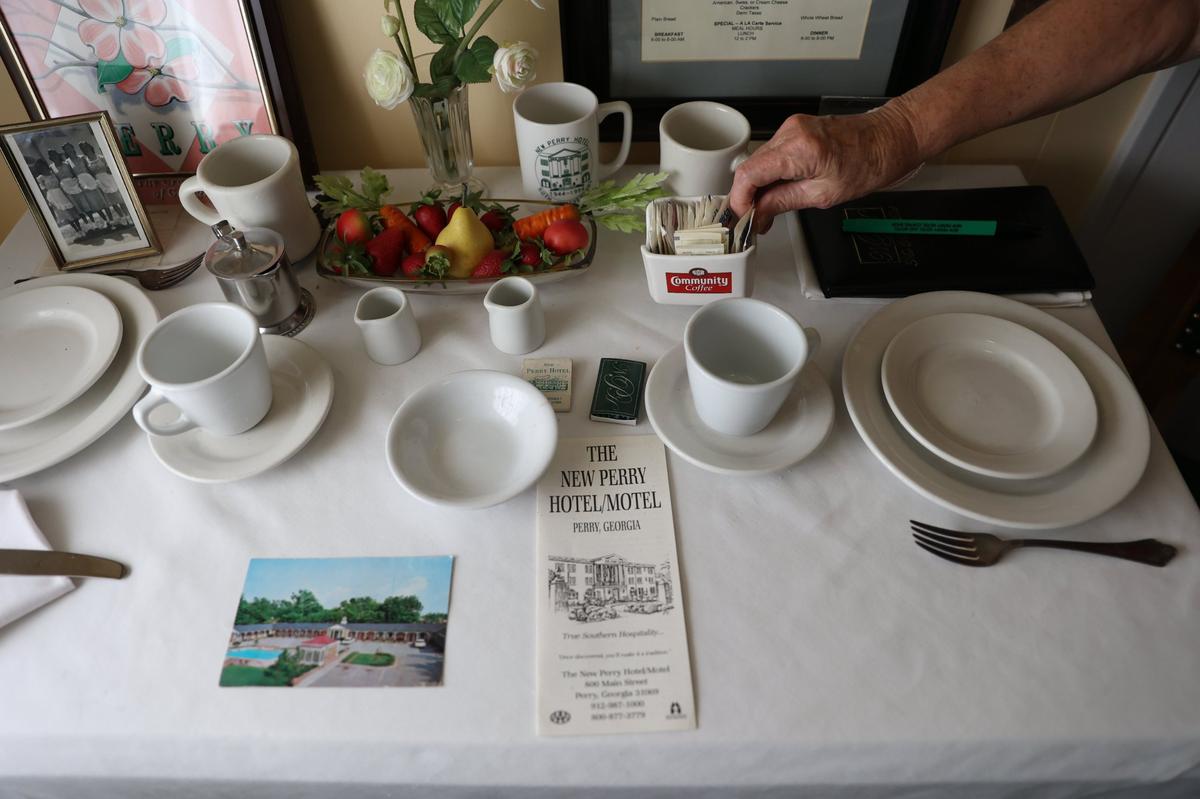 A replica of a table setting common at the New Perry Hotel sits in the Perry Area Historical Museum on Thursday, Aug. 22, 2024, in Perry, Georgia. The New Perry Hotel stood as a town staple for decades before being demolished this summer. Its history is preserved through a permanent exhibit at the museum.