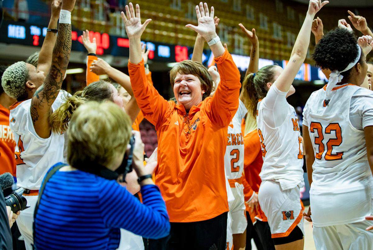 The Mercer women’s basketball team celebrates after defeating Furman 73-54 in the SoCon Ingles Basketball Championship Saturday afternoon at the Harrah’s Cherokee Center in Asheville, N.C.