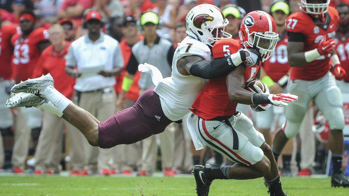 Louisiana-Monroe safety Mitch Lane tackles Georgia wide receiver Terry Godwin (5) during the first half of Saturday’s game.