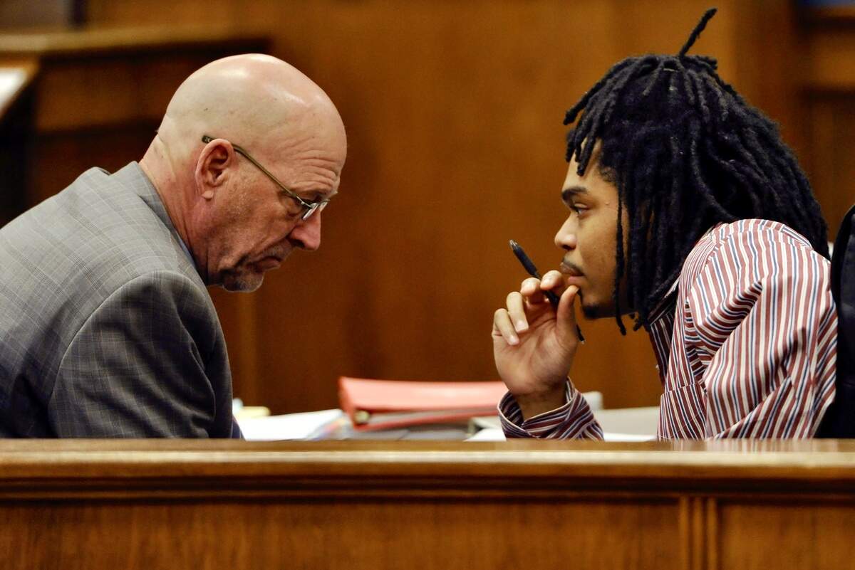 Defense attorney Paul Christian, left, with Quintavious Hutchings at trial.