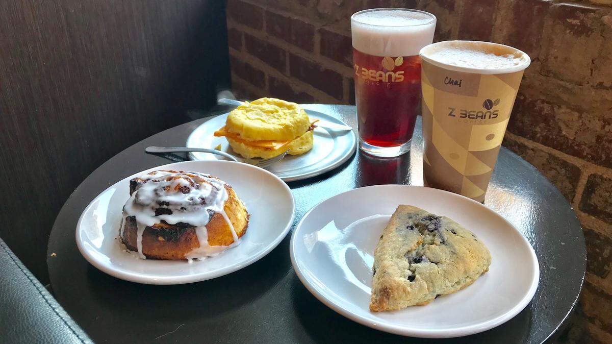 Egg-on-egg sandwich, blueberry basil nitro, cafe latte, scone, and cinnamon roll are among the items on the Z Beans menu.