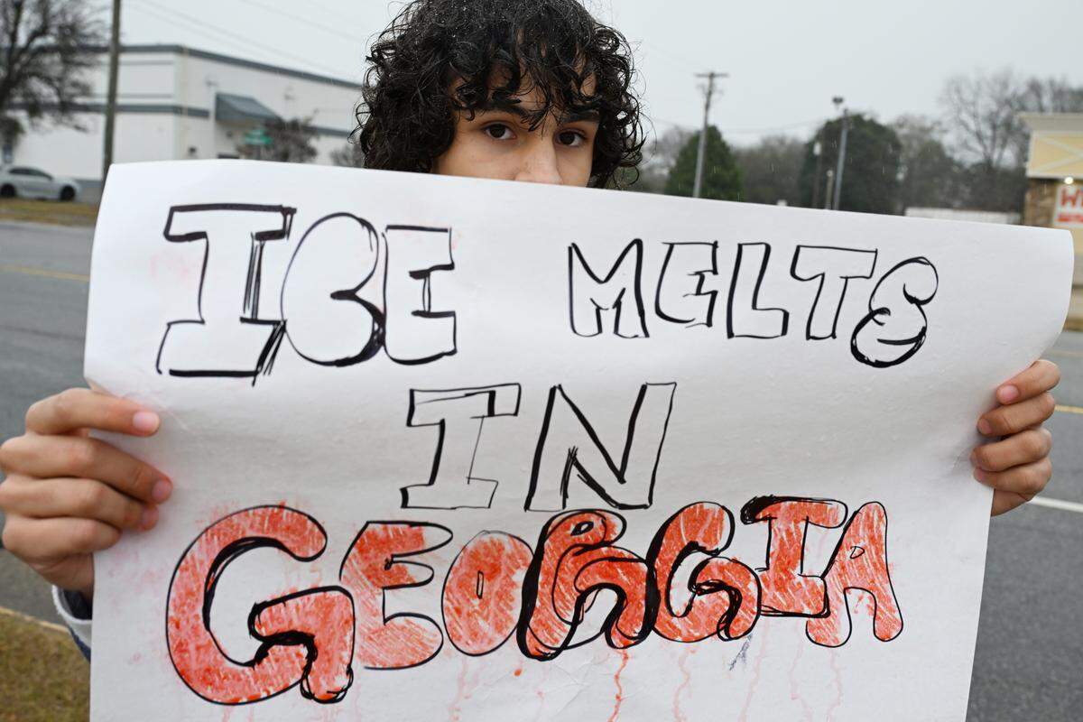 A Northside High School student holds a protest sign during a school day protest against U.S. Immigration and Customs Enforcement (ICE) on Friday, Jan. 23, 2026, in Warner Robins, Georgia. Around a dozen Northside students as well as community members marched to protest recent practices by ICE under the Trump administration.