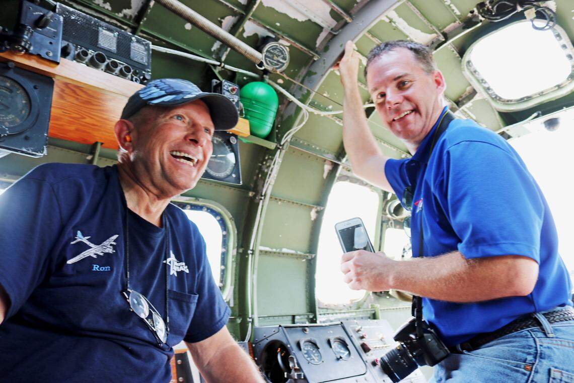 Ron Barber, left, a volunteer on the B-17 restoration at the Museum of Aviation, and Dave Anderson, a museum manager, ride on a B-17 as it flew over Atlanta on Saturday.
