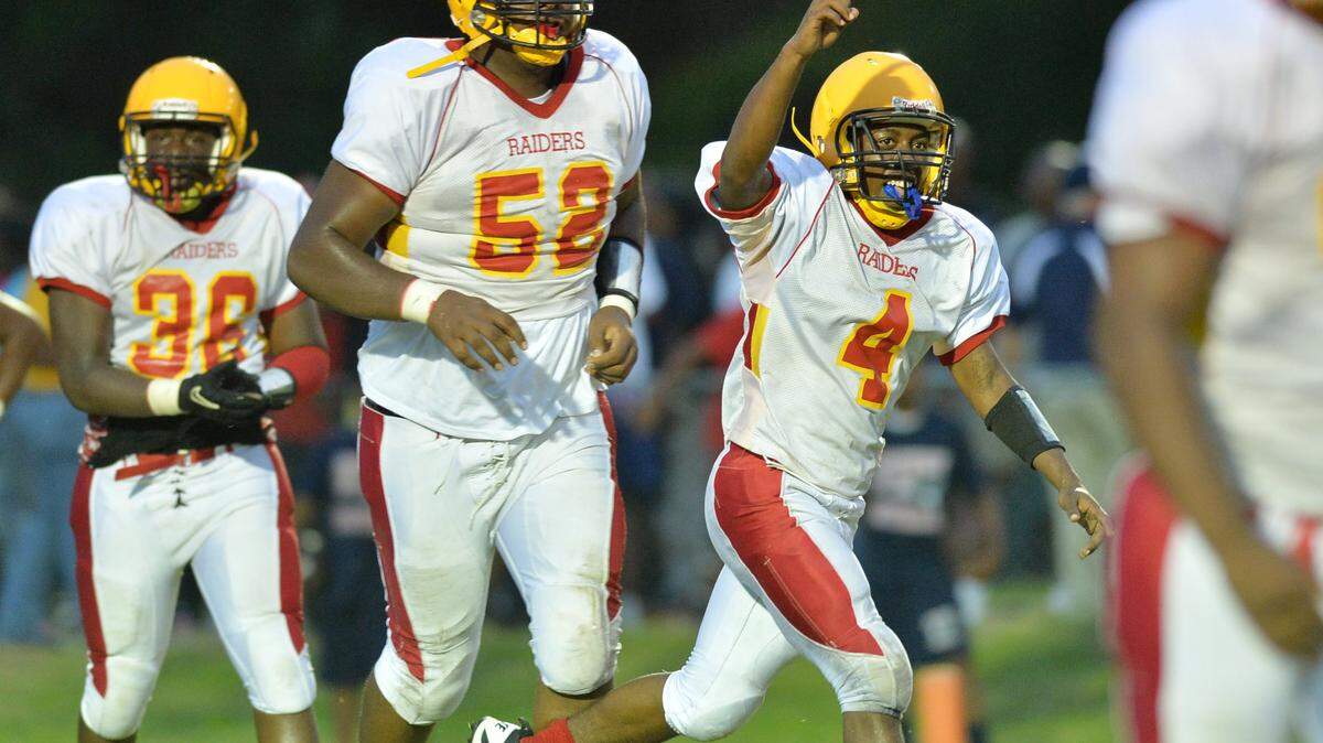 Northeast running back Jerome Grayer (4) celebrates the first Raiders touchdown Friday night against Southwest.