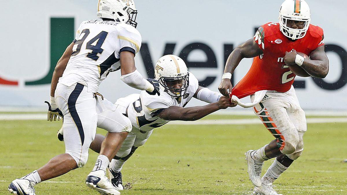 Georgia Tech defensive back Lawrence Austin (20) attempts to stop Miami's Joseph Yearby during their Nov. 21 game in Miami.