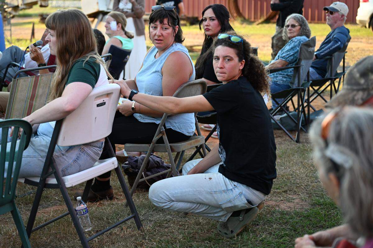 Twiggs County residents Julia Asherman (left) and Lena White speak to other residents during a planning meeting ahead of the Twiggs County Board of Commissioners vote on Tuesday, Sept. 16, 2025, in Dry Branch, Georgia. Commissioners will vote on whether to move forward with the proposed data center in the county in a vote on Thursday. 
