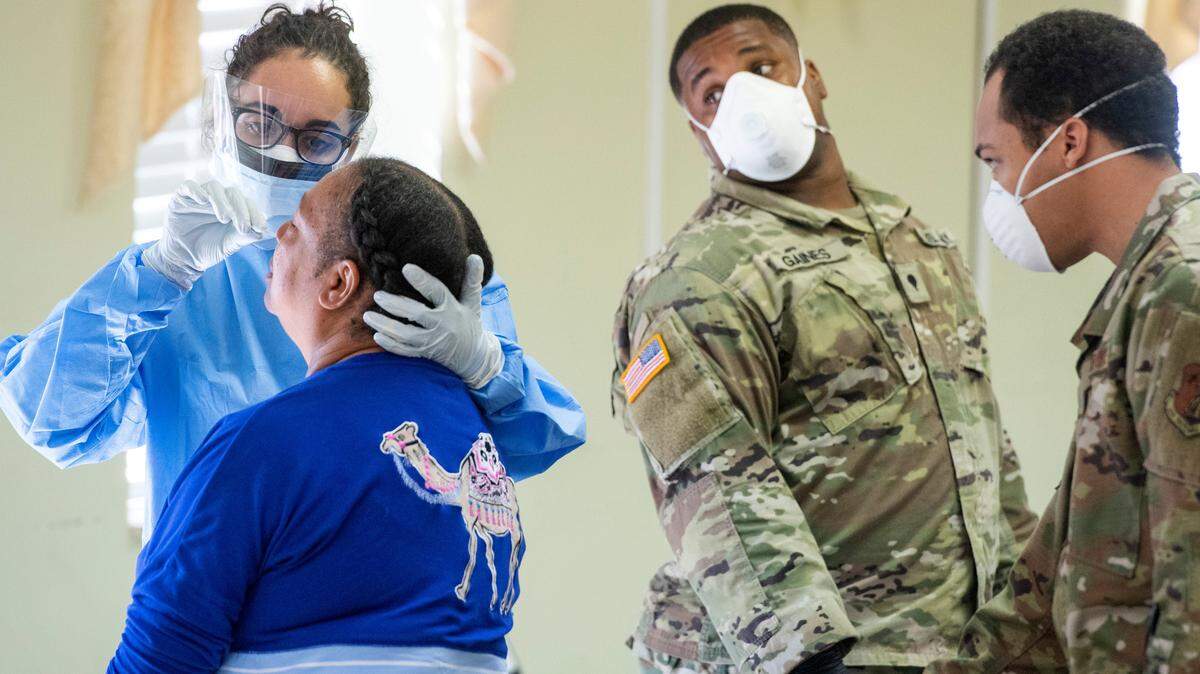 JASON VORHEES/THE TELEGRAPH Macon, GA, 04282020 Sgt. Jessica Borg, left, with the 148th Brigade Support Battalion performs a deep nasal swab COVID-19 test Tuesday at Ebenezer Missionary Baptist Church.