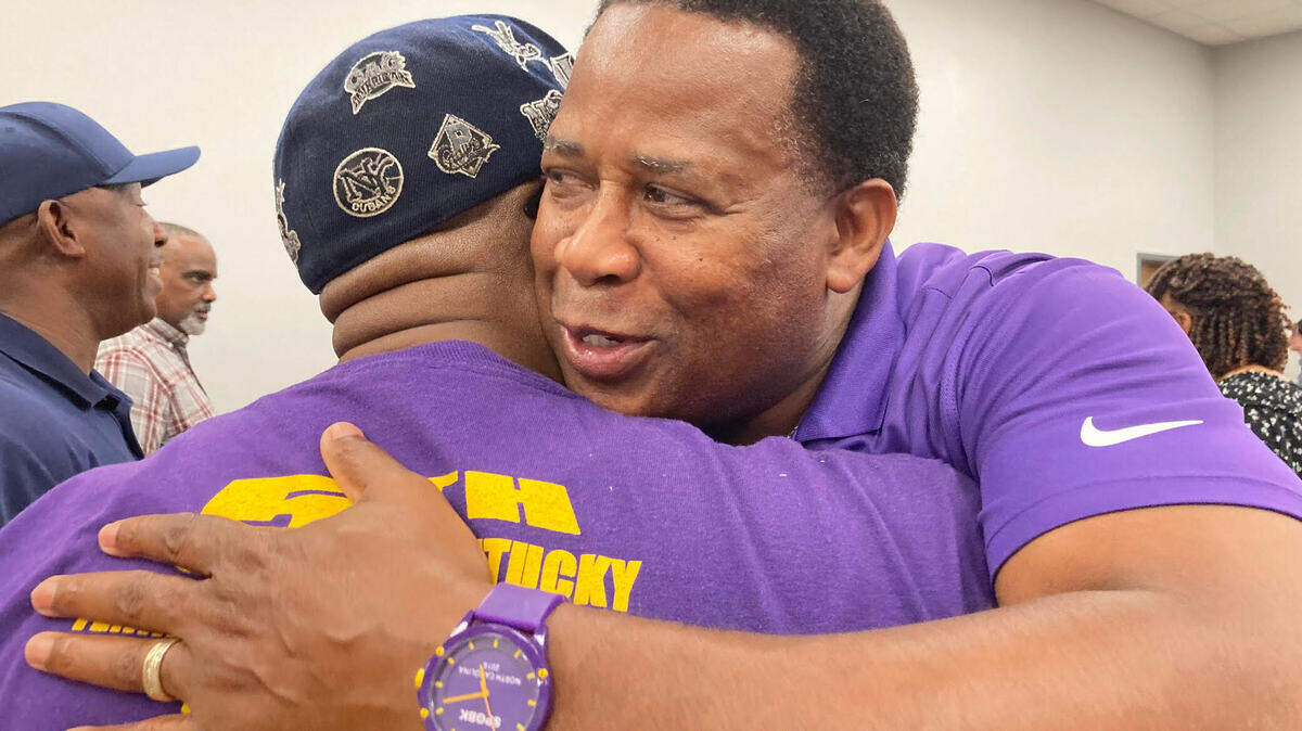 District 7 school board candidate Clyde Jackson gets a hug from a supporter after the Houston County Board of Elections reverses its decision to disqualify him.