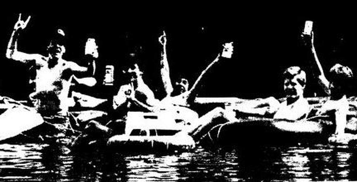 Participants raise an impromptu toast in what proved to be the final incarnation of the Ocmulgee River raft race in May 1981.