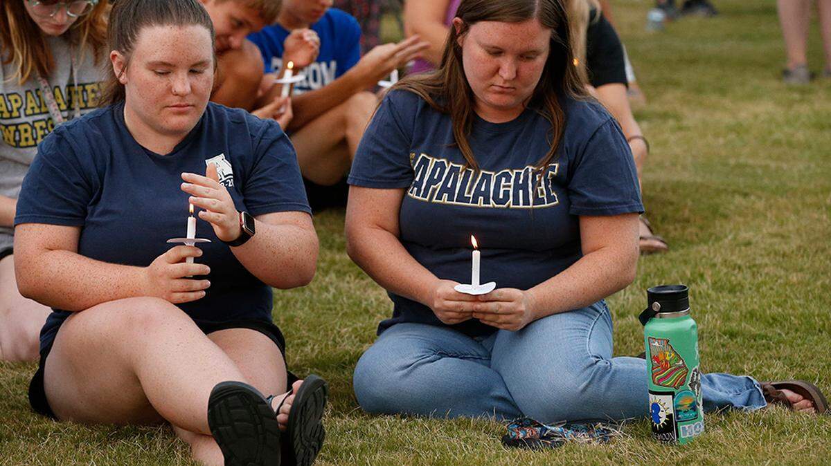 Apalachee High School students hold candles at a vigil for the mass shooting victims in Winder, Ga., on Wednesday, Sept. 4, 2024.