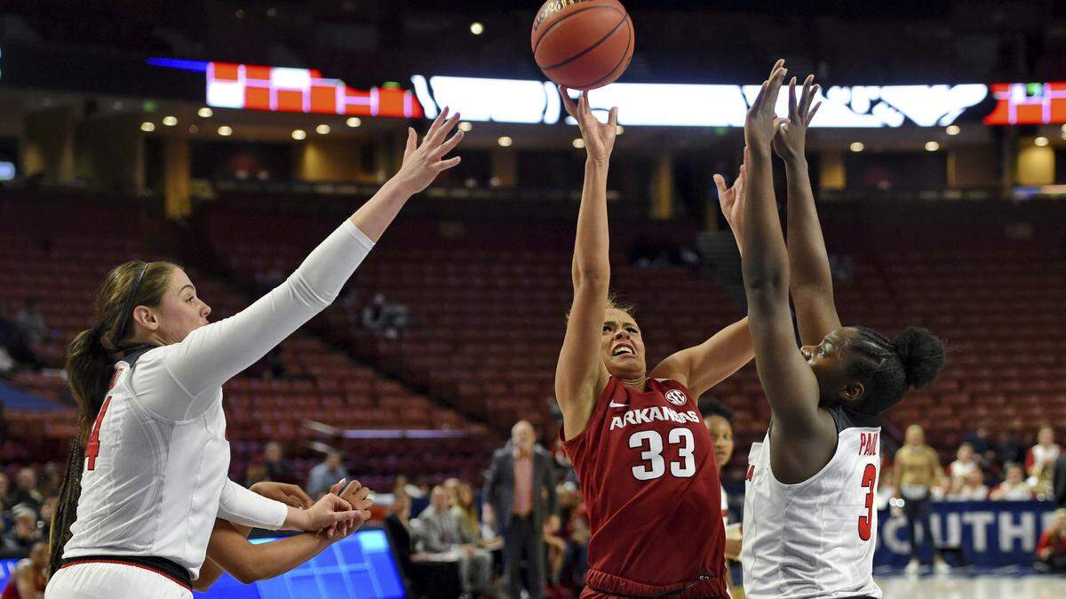 Arkansas’s Chelsea Dungee (33) drives against Georgia’s Jenna Staiti, left, and Stephanie Paul during the first half of a women’s Southeastern Conference NCAA college basketball tournament game Thursday, March 7, 2019, in Greenville, S.C. (AP Photo/Richard Shiro)