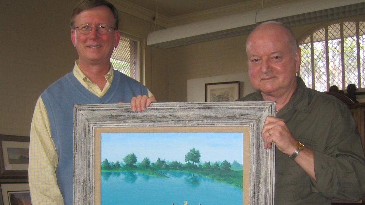 Ed Grisamore with Butler Brown and the original artwork of a little boy fishing. The two were in the old train depot in Forsyth during the Forsythia Festival in 2007.