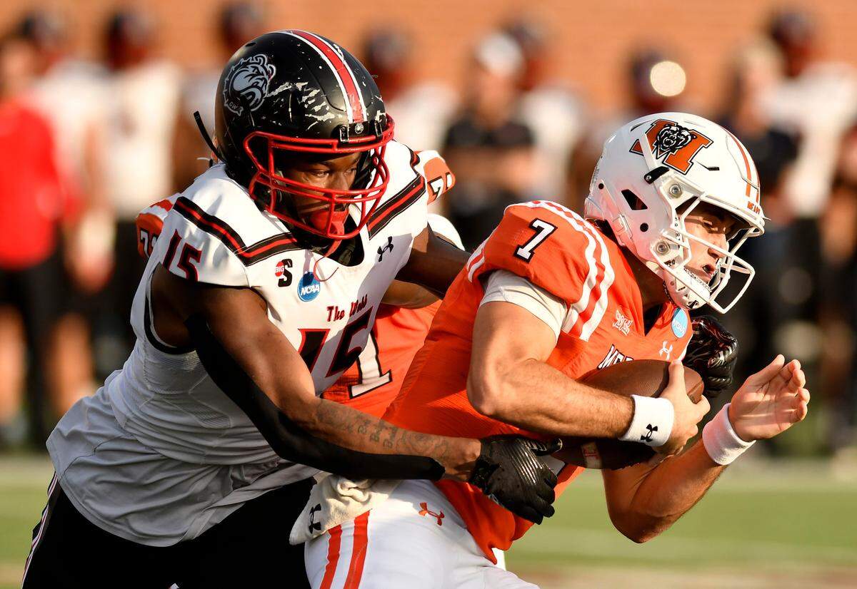 Mercer quarterback Carter Peevy (7) is pressured by Gardner-Webb defensive end Brice Bass (15) during their FCS playoff game Saturday in Macon.