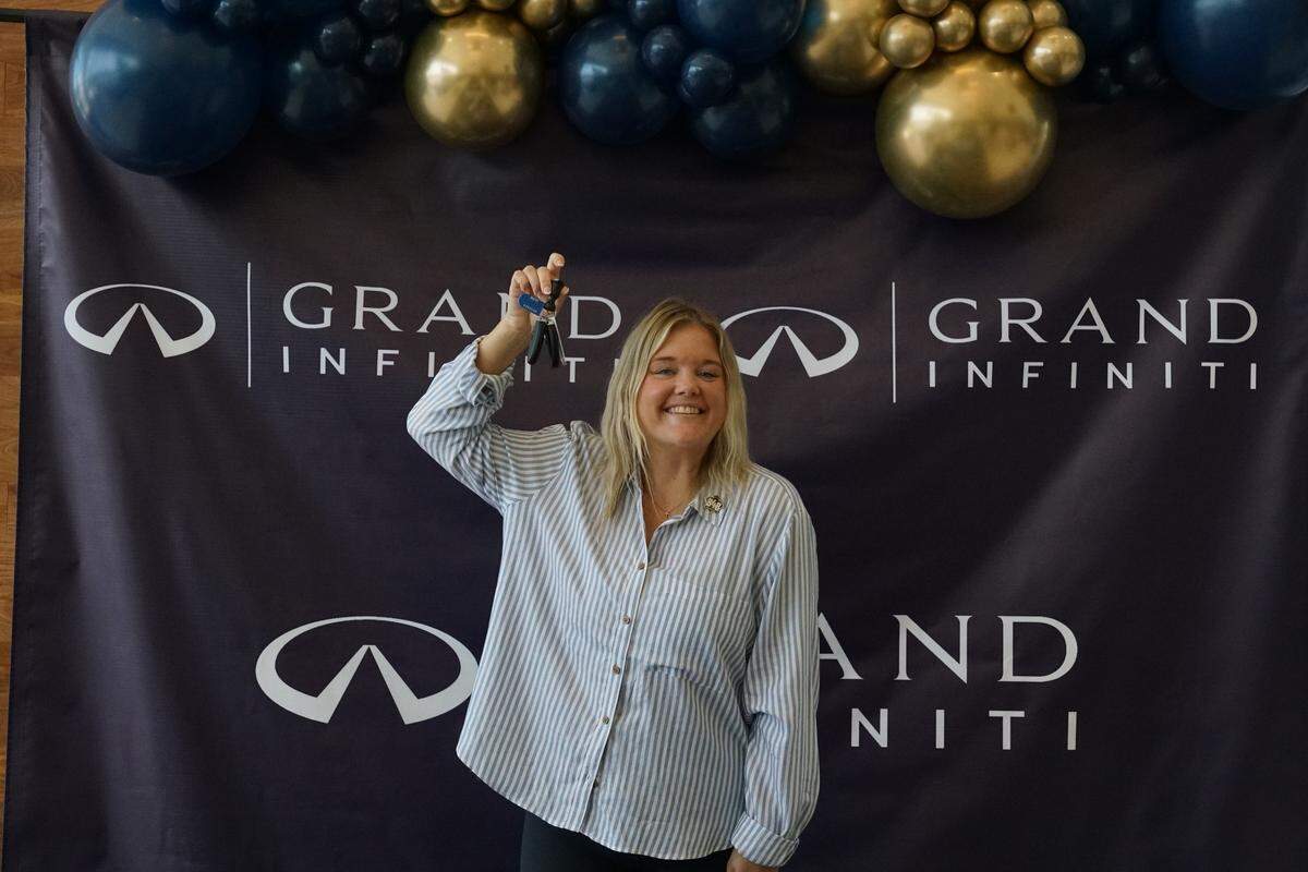 2025 Bibb County School District Teacher of the Year Sarah Mallett poses with keys to a brand-new 2024 QX60 Infiniti on Saturday, Sept. 21, 2024 in Macon, Georgia. Mallett teaches at Howard Middle School and was awarded a year lease on the car as a part of Grand Infiniti’s grand opening.