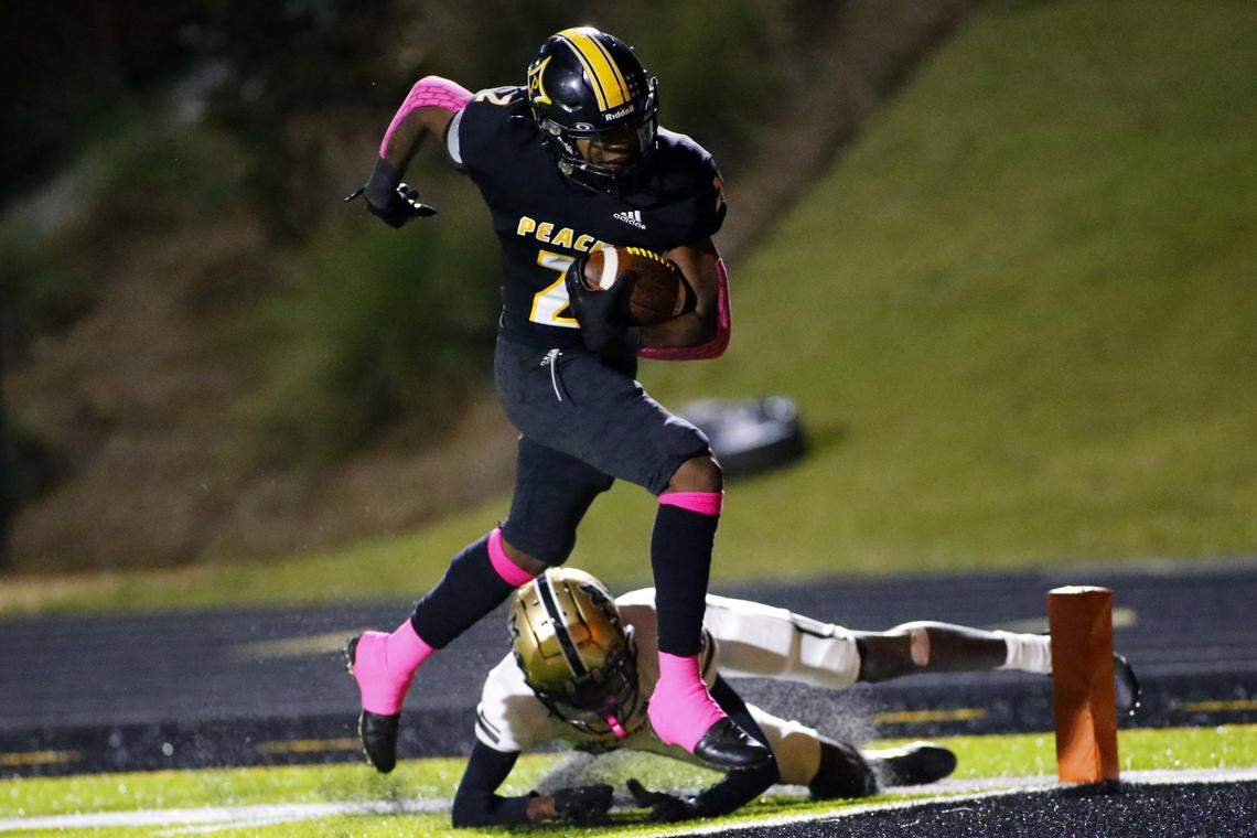 Peach County’s Christian Martin (2) eludes a would be tackle for a touchdown during the Trojans’ 35-18 win over Mary Persons Friday night.