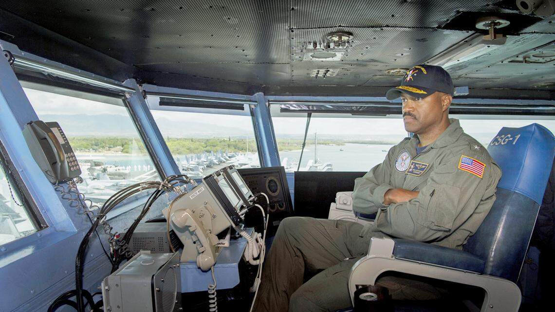 Rear Adm. Alvin Holsey observes from the flag bridge Nimitz-class aircraft carrier U.S.S. Carl Vinson arriving in Pearl Harbor, Hawaii, on June 26.