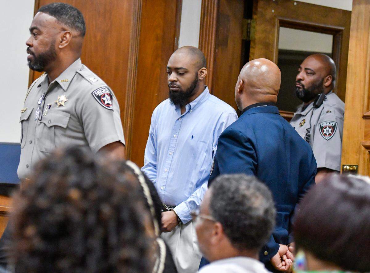 Caesar Zamien Crockett walks into a Bibb County Superior courtroom during his murder trial Thursday morning. Crockett is accused of shooting the grandparents and aunt of his child in 2020.