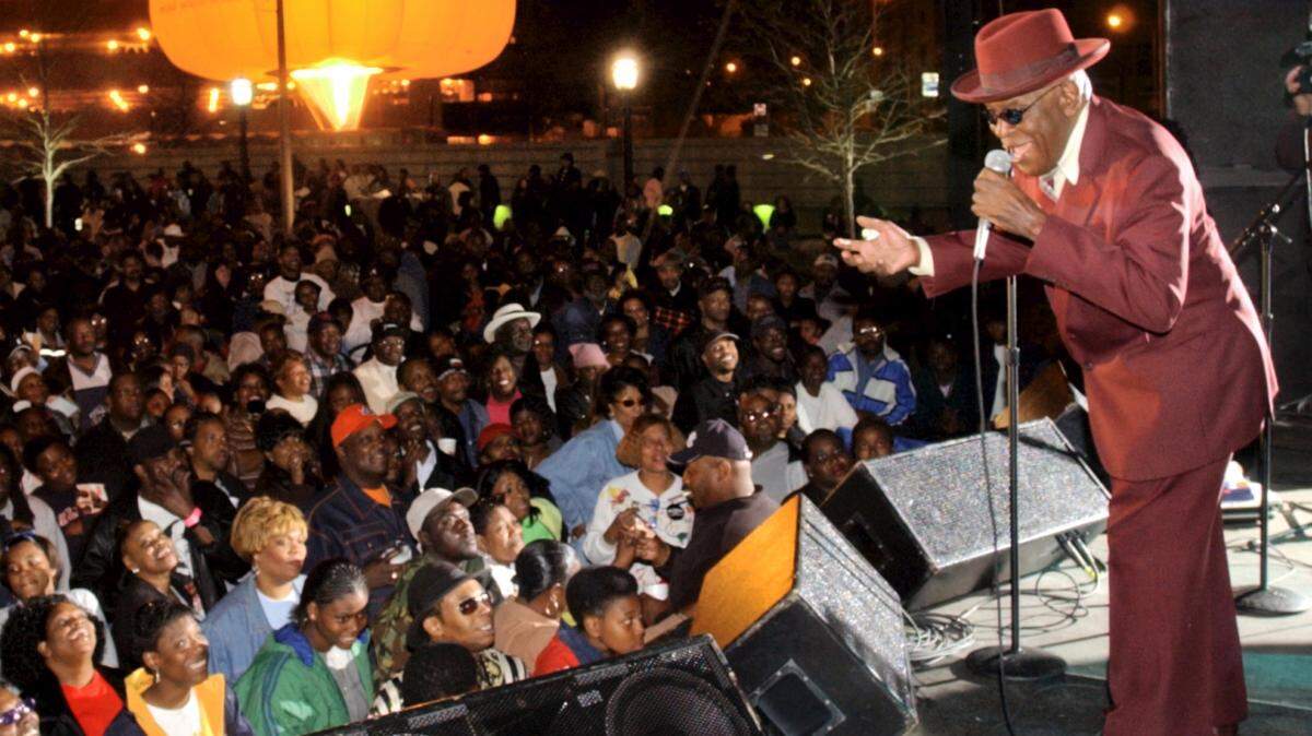 Photo by Beau Cabell/The Telegraph 
 Ray “Satellite Papa” Brown sings the blues for a Cherry Blossom Street Party crowd in 2002.