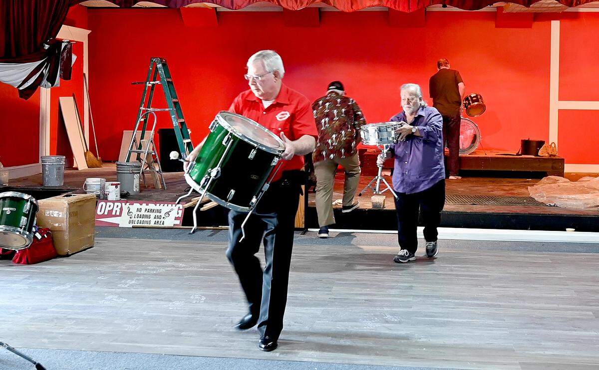 Grover Jewell, president of the Powersville Opry helps move a drum set off the stage at the Opry’s new location in Hawkinsville March 31. The Opry is moving to Hawkinsville after 27 years at its former location outside of Byron.