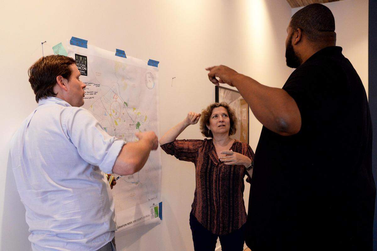 JENNA EASON/THE TELEGRAPH Macon, GA, 09/24/2019: Matt Chalfa, the director of preservation field services at the Historic Macon Foundation, Frances De la Rosa and Karaleus White, left to right, discuss where a specific community site is located at Historic Macon’s kickoff event for its Scenic Preservation Index on Tuesday.
