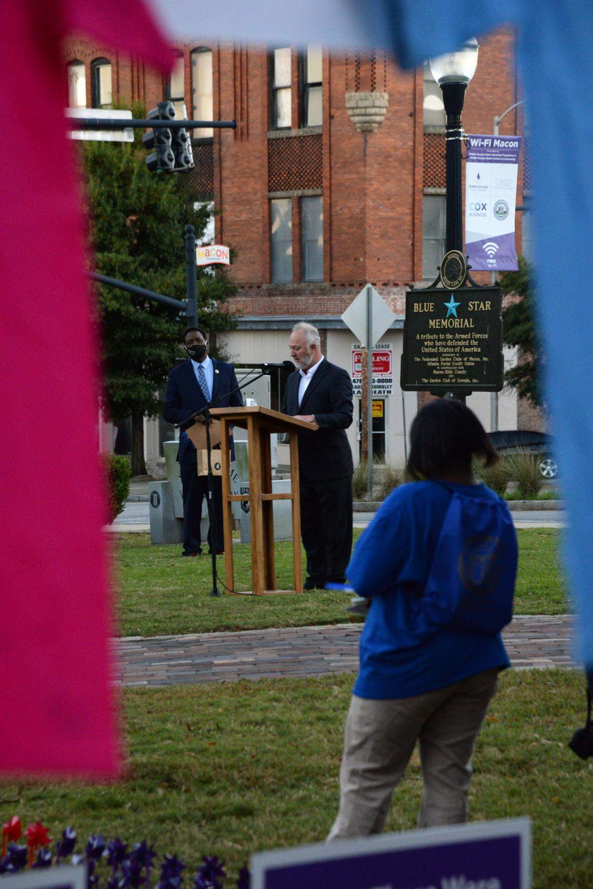 Macon Mayor Lester Miller speaks Tuesday at a candlelight vigil for Domestic Violence Awareness Month in Rosa Parks Square. The purple windmills represent the people who have lost their lives to domestic violence in Georgia, and the red windmills represent victims from Middle Georgia. The t-shirts were decorated by victims of domestic violence.