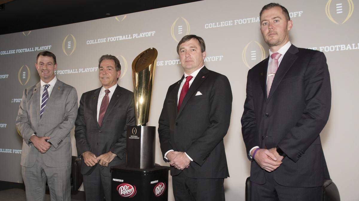 Clemson's Dabo Swinney, Alabama's Nick Saban, Georgia's Kirby Smart and Oklahoma's Lincoln Riley pose for a photo at the College Football Playoff news conference.